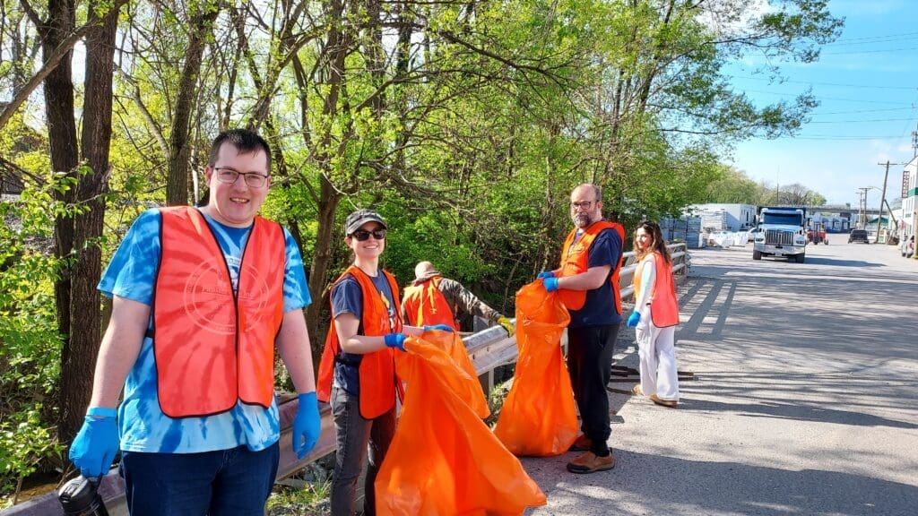 People with orange vests and orange bags participating in the Blacks Run Clean Up Day.